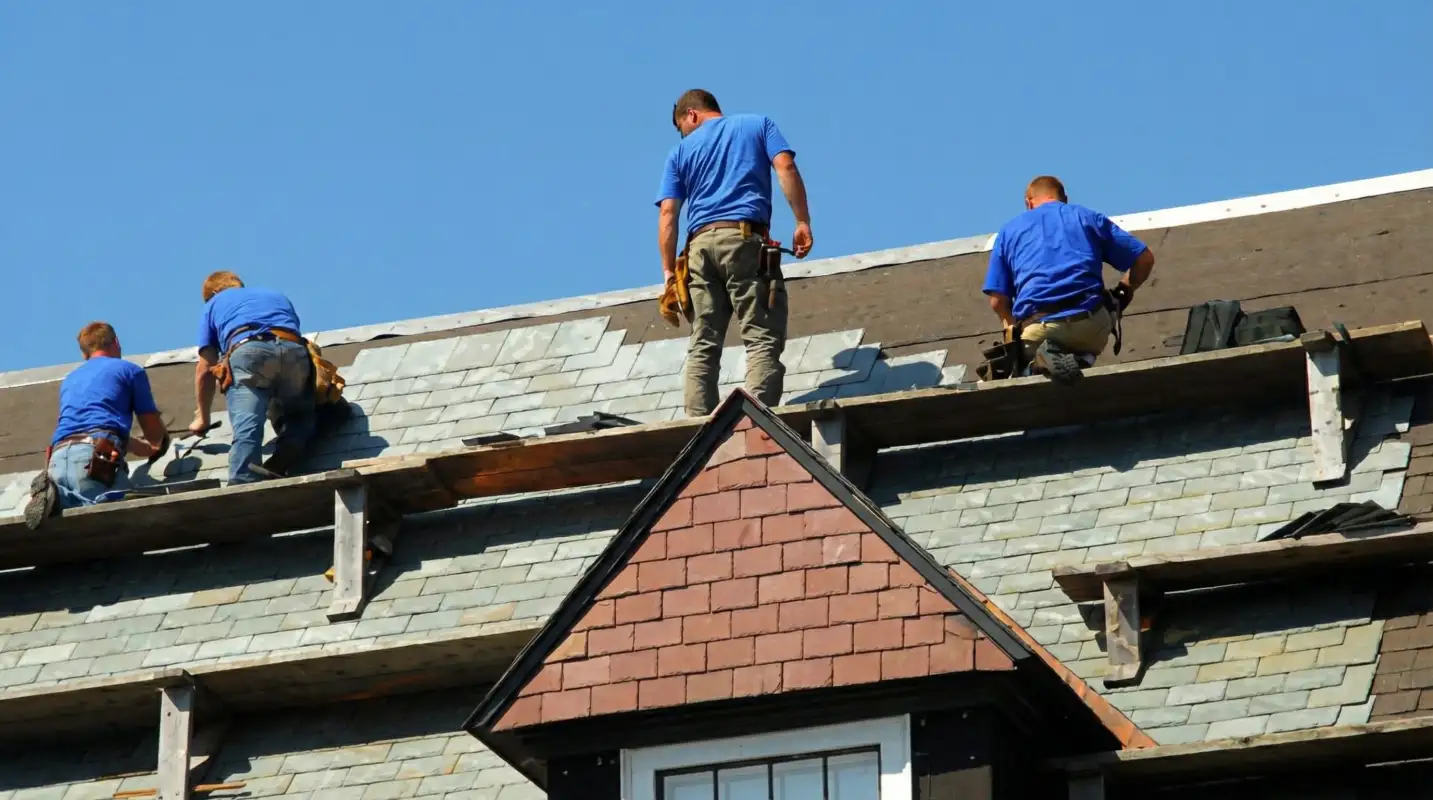 Roof replacement in progress with a team of professional contractors installing new shingles on a residential home in Baltimore, MD