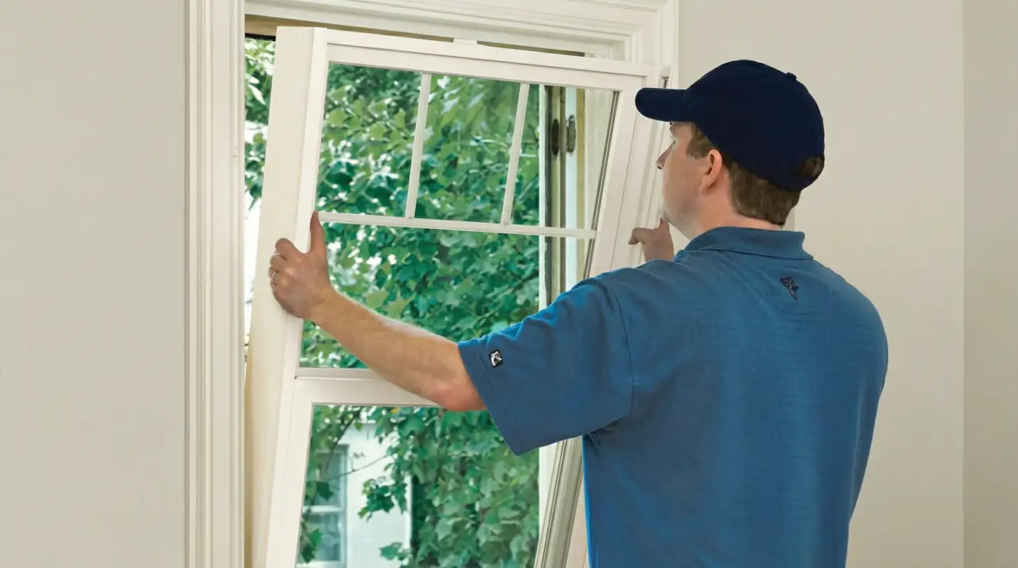 Professional contractors performing a residential window insulation and replacement service in Baltimore, MD